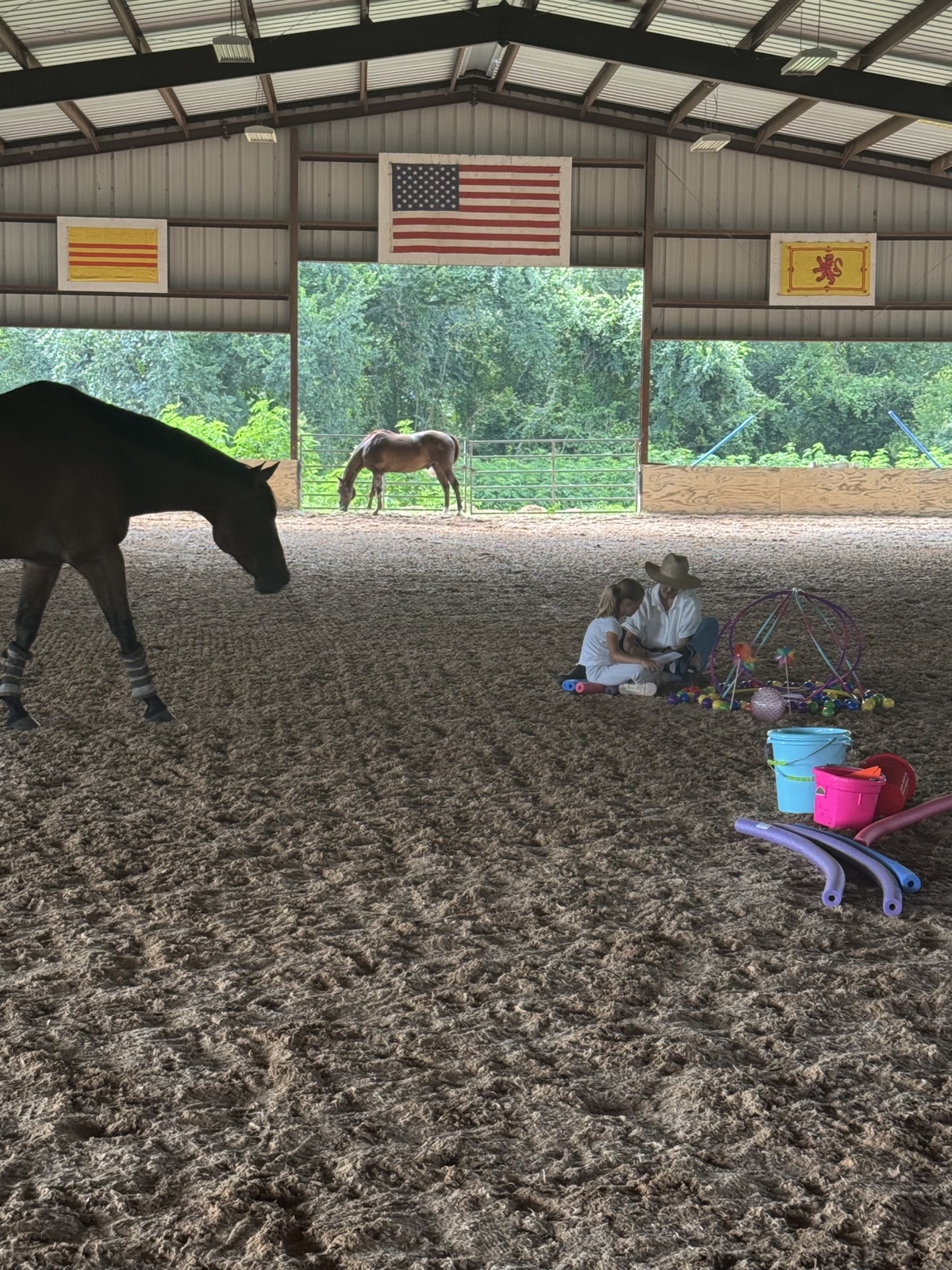 A mother and daughter during a session in the covered arena